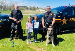 officers posing with k9s and kids