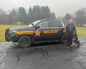 officer and k9 in front of vehicle
